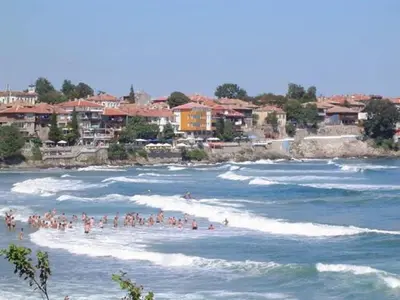 a group of people in the water at a beach at Guest House Rusalka in Sozopol