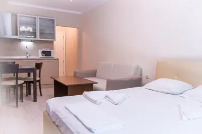 a hotel room with two beds and a kitchen at Sozopoli Style Club in Sozopol