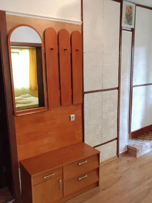 a dressing room with a mirror and a wooden dresser at Apart Hotel Hetodon in Sozopol