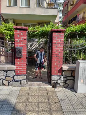 a man walking through an open door in a brick building at Apart Hotel Hetodon in Sozopol