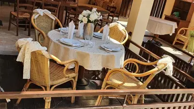 a table with chairs and a white table cloth on it at Hotel Villa Bora in Sunny Beach