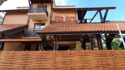 a building with a wooden fence in front of it at Hotel Villa Bora in Sunny Beach