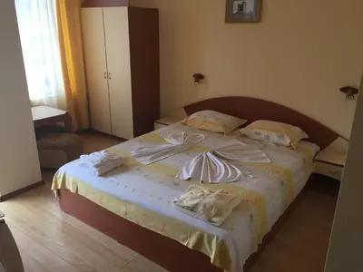 a bedroom with a bed with towels on it at Guest House Hetodon in Sozopol