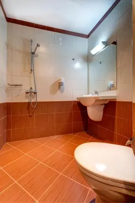 a bathroom with a toilet and a sink and a shower at Siena House in Sozopol