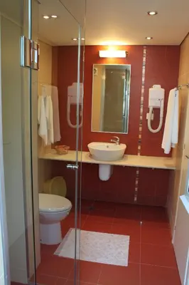 a bathroom with a toilet and a sink and a shower at Вилно селище 