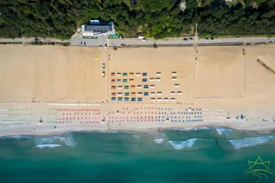 a cruise ship is docked at the beach at Вилно селище 