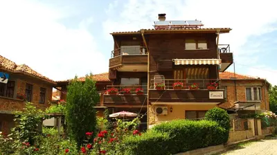 a building with balconies and flowers in front of it at Family Hotel Emilia in Sozopol