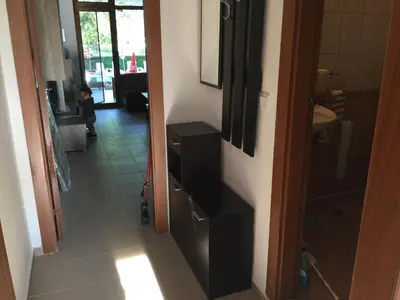 a small child standing in the hallway of a bathroom at Blue Summer in Sunny Beach