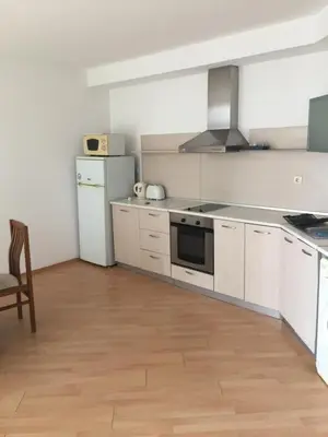 a kitchen with white cabinets and a white refrigerator at Blue Summer in Sunny Beach