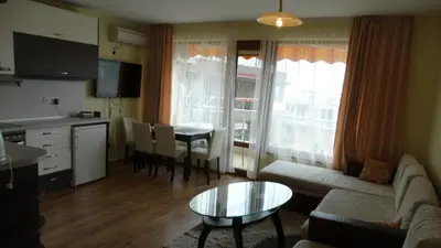 a living room with a couch and a table at Sunny Sands Studios in Burgas City