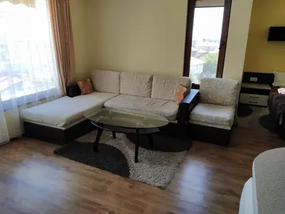 a living room with a couch and a coffee table at Sunny Sands Studios in Burgas City