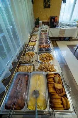 a buffet of different types of donuts and pastries at Hotel Luxor in Lozenets