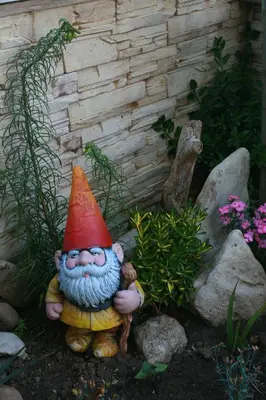 a gnome statue sitting in a garden at Hotel Luxor in Lozenets