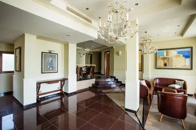 a living room with a chandelier at Helena VIP Villas and Suites - Half Board in Sunny Beach
