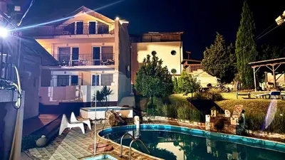 a house with a swimming pool in front of a house at Guest House Evin Rai in Byala
