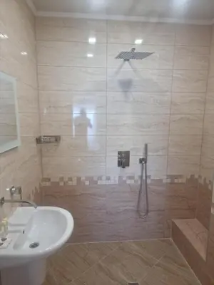 a bathroom with a shower and a sink at Family Hotel Alfa Vita in Sozopol