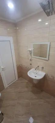 a bathroom with a sink and a mirror at Family Hotel Alfa Vita in Sozopol
