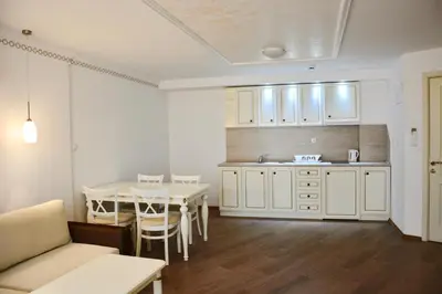a kitchen and dining room with a table and chairs at Golden Rainbow Beach Hotel in Sunny Beach