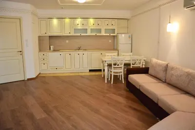 a living room with a couch and a kitchen at Golden Rainbow Beach Hotel in Sunny Beach