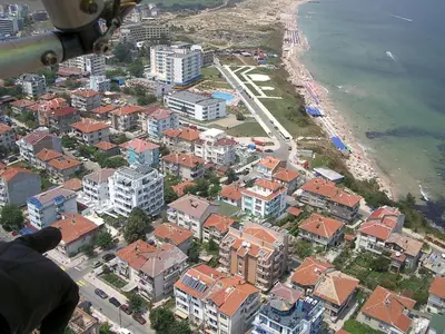 an aerial view of a city with buildings and the ocean at Hotel Levteri in Primorsko