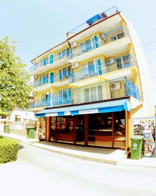 a building with blue balconies on a street at R&G Hotel in Nesebar