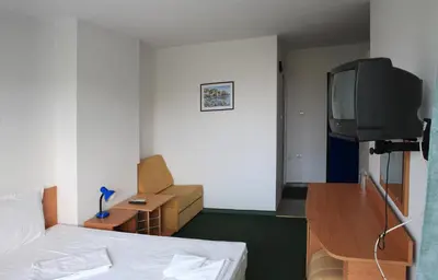 a hotel room with a bed and a television at R&G Hotel in Nesebar