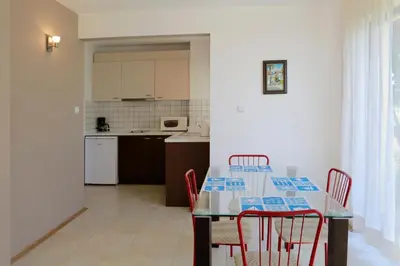 a dining room and kitchen with a table and chairs at Saint Stefan Villas in Sozopol