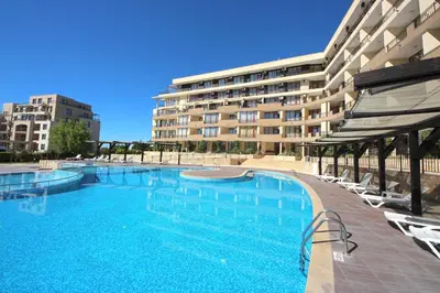 a large swimming pool in front of a building at Menada Luxor Apartments in Sveti Vlas