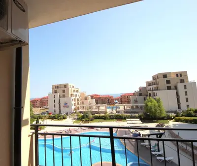a view of a pool from a balcony of a building at Menada Luxor Apartments in Sveti Vlas