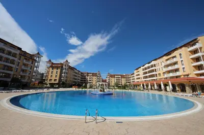 a large swimming pool in the middle of some buildings at Menada Royal Sun Apartments in Sunny Beach