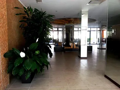 a lobby with potted plants in a building at Menada Royal Sun Apartments in Sunny Beach