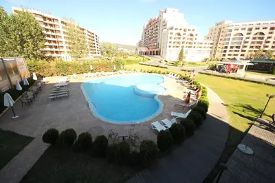an overhead view of a large swimming pool in a city at Menada Sunny Beach Plaza Apartments in Sunny Beach