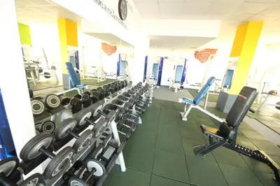 a gym with rows of treadmills and machines at Menada Grand Kamelia Apartments in Sunny Beach