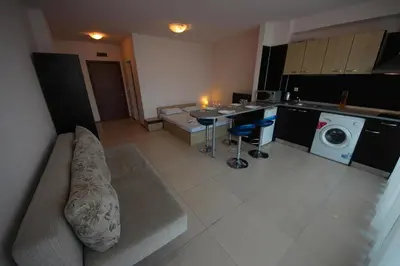 a kitchen with a couch and a washing machine at Menada Grand Kamelia Apartments in Sunny Beach