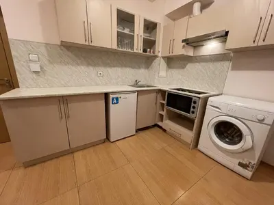 a kitchen with a washing machine and a washer at Menada Grand Kamelia Apartments in Sunny Beach