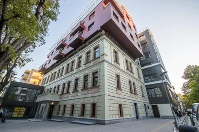 a tall white building with a lot of windows at City Apartments Triumph in Varna City