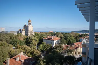a view of a city with a building in the distance at City Apartments Triumph in Varna City