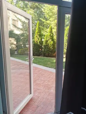 an open sliding glass door with a view of a courtyard at Rose Garden Omax Apartments in Sunny Beach