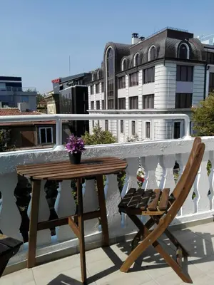 a wooden table and a chair on a balcony at INFINITY Blue 1 in Burgas City
