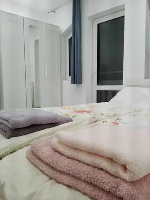 a bedroom with two beds with towels on them at INFINITY Blue 1 in Burgas City