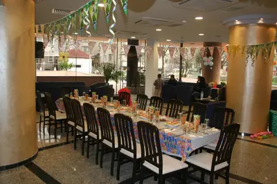 a long table with chairs in a restaurant at Aparthotel VRIS in Tsarevo
