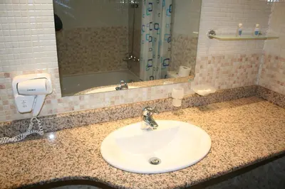 a bathroom counter with a sink and a mirror at Aparthotel VRIS in Tsarevo