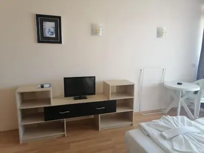 a living room with a tv on a stand at Aparthotel VRIS in Tsarevo