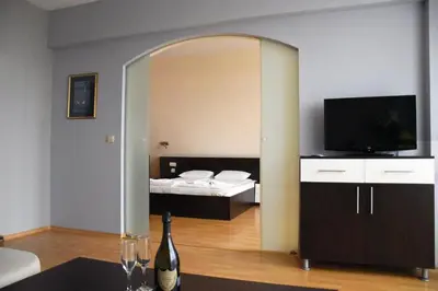 a large mirror in a room with a bed at Aparthotel VRIS in Tsarevo