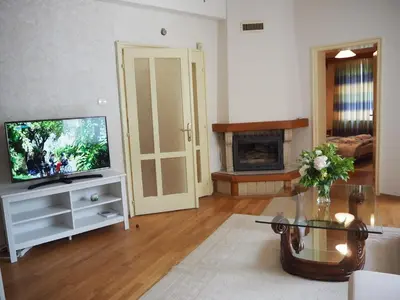 a living room with a television and a fireplace at Yoana Apartment in Varna City