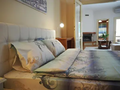 a bedroom with a bed with a white headboard at Yoana Apartment in Varna City