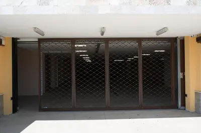 an open garage door with a metal gate at Villa EM in Lozenets