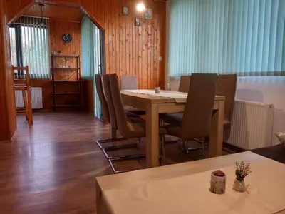 a dining room with a table and chairs at Villa Kalina in Lozenets