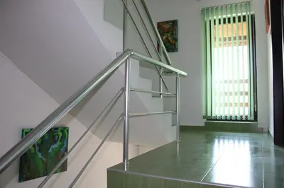 a staircase with a glass railing in a house at Villa Kalina in Lozenets
