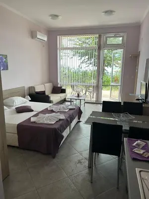 a bedroom with a bed and a couch and a table at Villa Maria 2 in Chernomorets